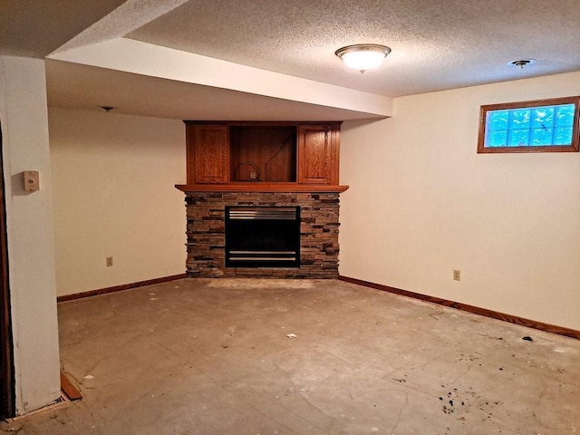 unfurnished living room with a textured ceiling and a stone fireplace