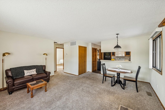 interior space featuring a textured ceiling and carpet