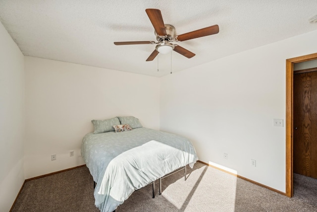 carpeted bedroom featuring ceiling fan and a textured ceiling