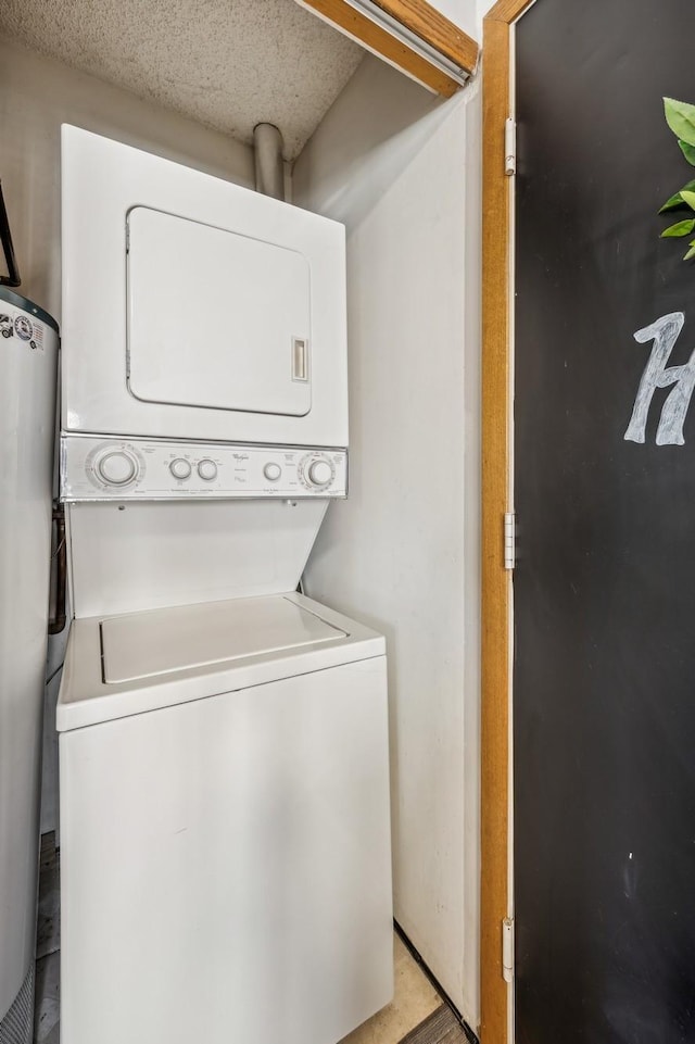 laundry area featuring stacked washer and dryer and water heater