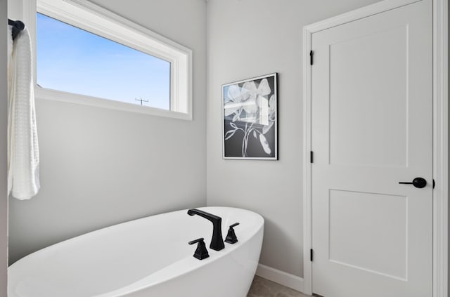 bathroom with a tub to relax in