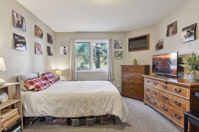 carpeted bedroom featuring a textured ceiling