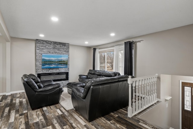 living room featuring a fireplace and dark wood-type flooring