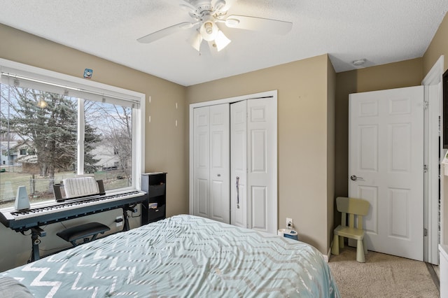 carpeted bedroom featuring a textured ceiling, a closet, ceiling fan, and cooling unit