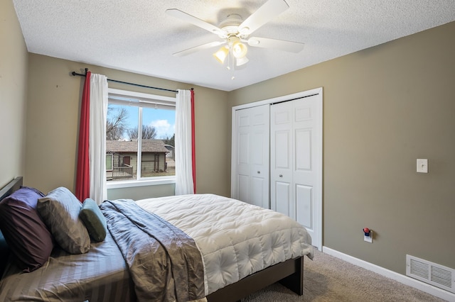 bedroom featuring carpet flooring, a textured ceiling, a closet, and ceiling fan