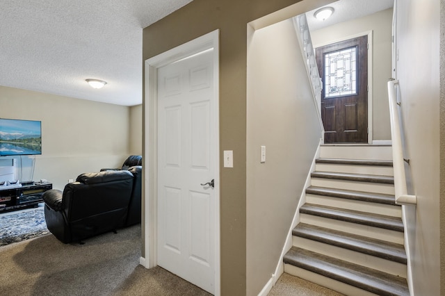 staircase with carpet and a textured ceiling