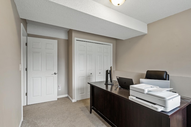 carpeted office with a textured ceiling