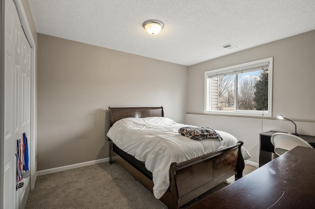 bedroom with carpet flooring, a textured ceiling, and a closet