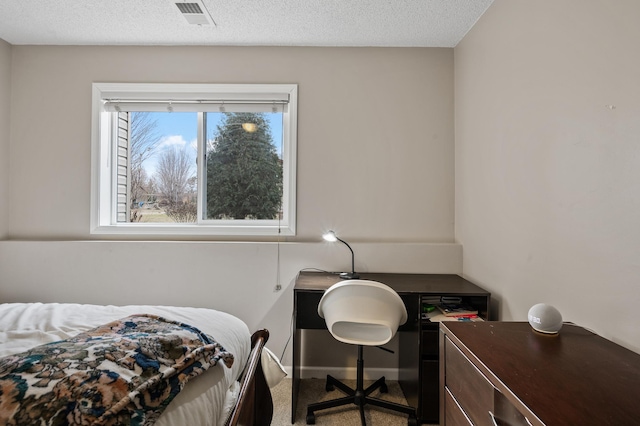 bedroom featuring carpet flooring and a textured ceiling