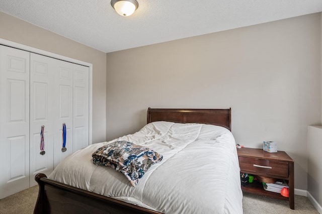 carpeted bedroom with a closet and a textured ceiling