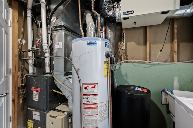 utility room featuring water heater