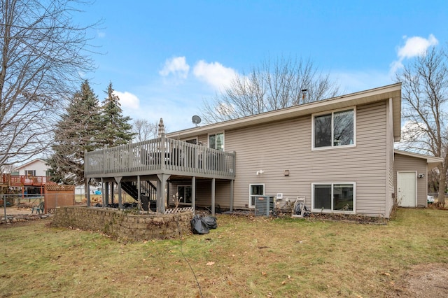 back of property with a lawn and a wooden deck