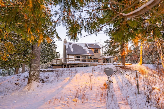 snow covered house with a deck