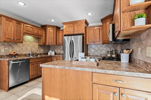 kitchen featuring stainless steel appliances, light tile patterned flooring, sink, and decorative backsplash