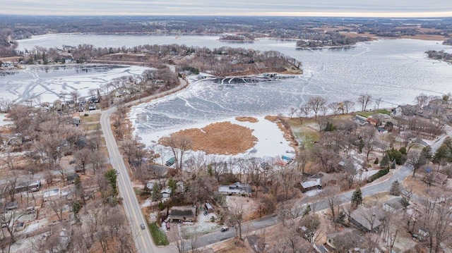 snowy aerial view with a water view