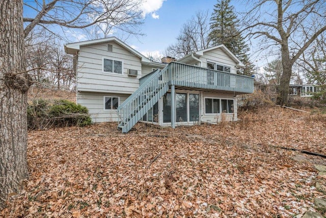 rear view of house with a sunroom and a deck