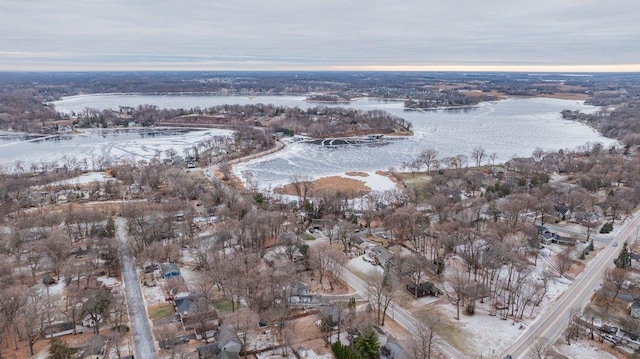 snowy aerial view featuring a water view