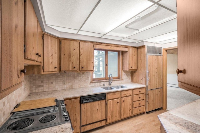 kitchen with paneled appliances, backsplash, light hardwood / wood-style flooring, and sink