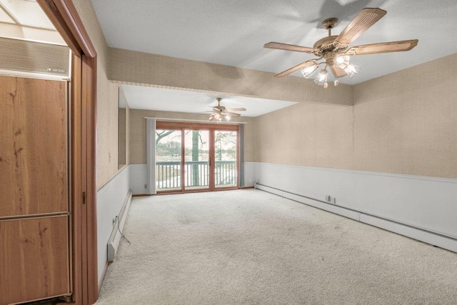 empty room with ceiling fan, light colored carpet, and a baseboard radiator