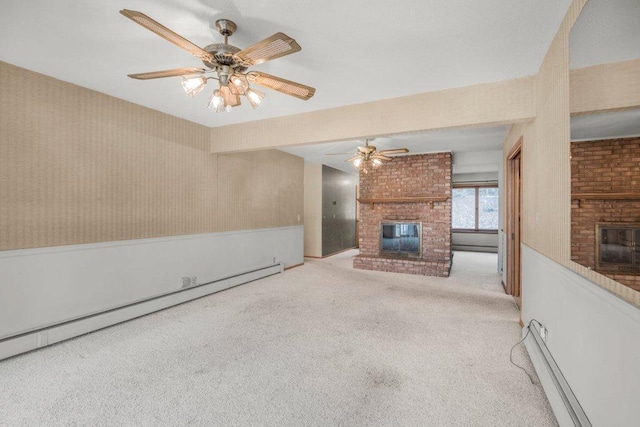 unfurnished living room with a fireplace, light carpet, and a baseboard heating unit