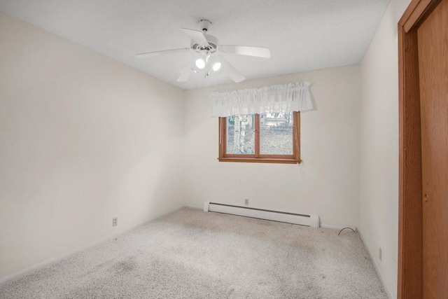 carpeted spare room with baseboard heating and ceiling fan