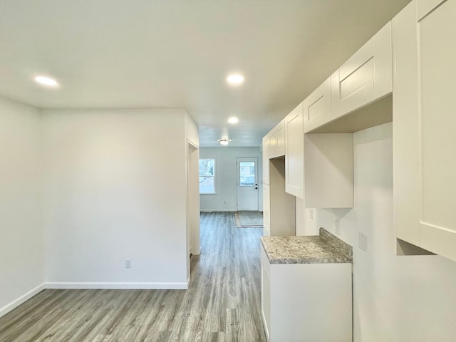 kitchen with white cabinets and light wood-type flooring