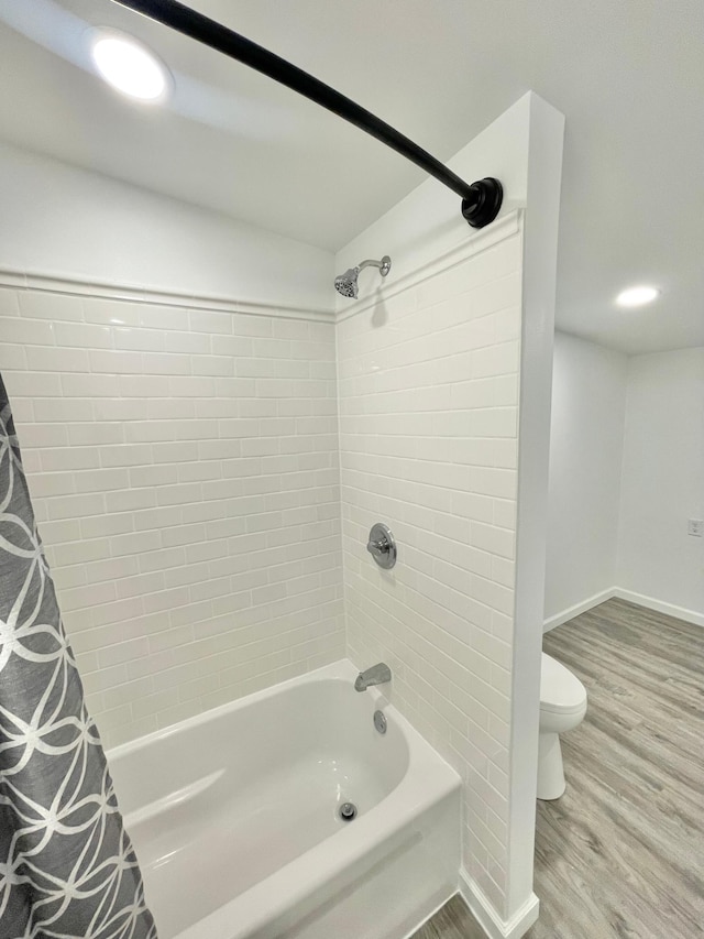 bathroom with toilet, shower / tub combo, and hardwood / wood-style flooring