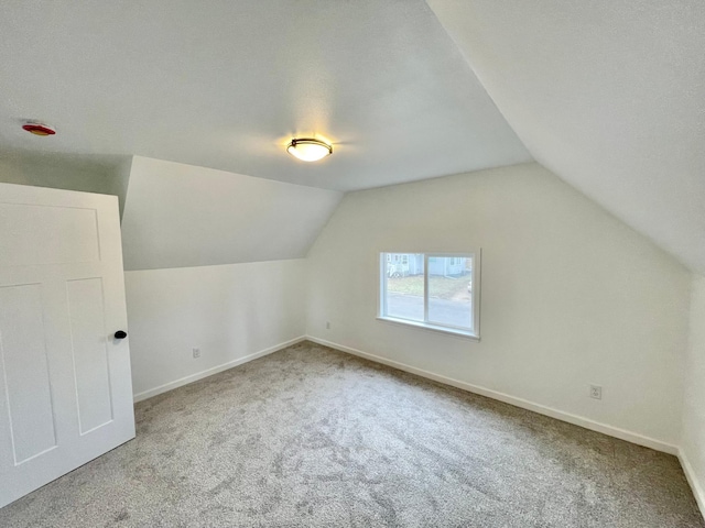 bonus room with carpet flooring, a textured ceiling, and vaulted ceiling