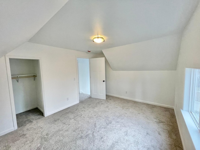 bonus room featuring light colored carpet and lofted ceiling