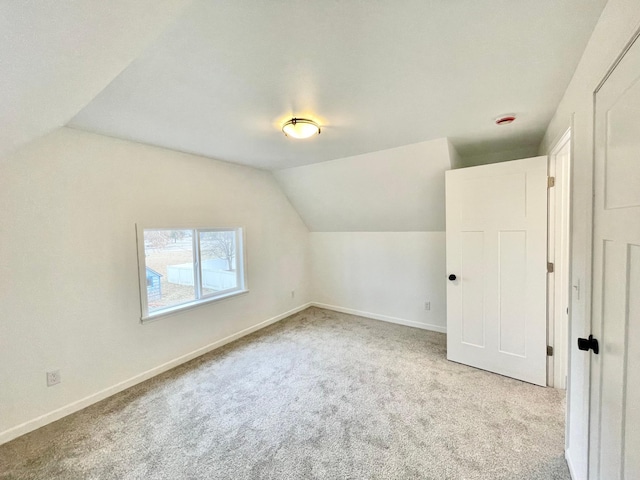 bonus room featuring light colored carpet and lofted ceiling