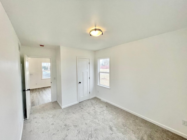 spare room with light colored carpet