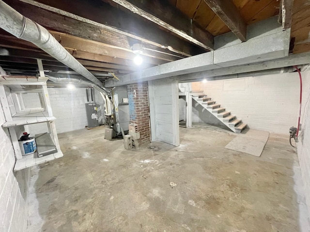 basement featuring heating unit and water heater