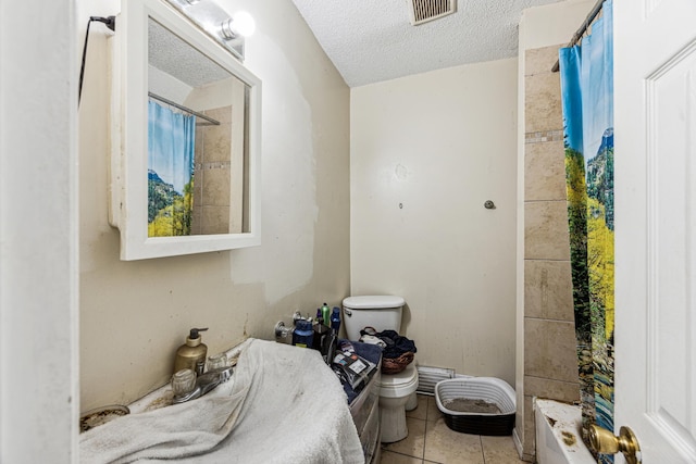 bathroom featuring toilet, shower / tub combo, a textured ceiling, and tile patterned floors