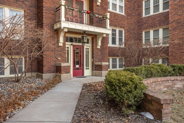 view of exterior entry featuring a balcony