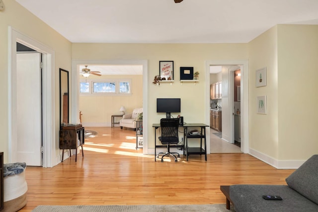 living room featuring light hardwood / wood-style flooring and ceiling fan