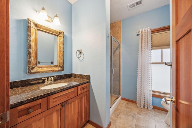 bathroom featuring vanity and a shower with door