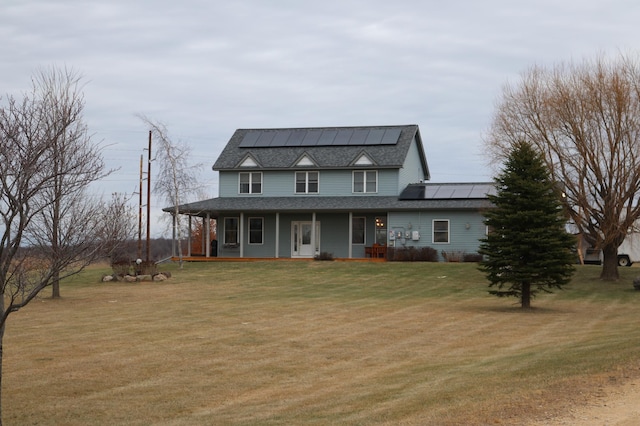 view of front facade with a front lawn, covered porch, and solar panels