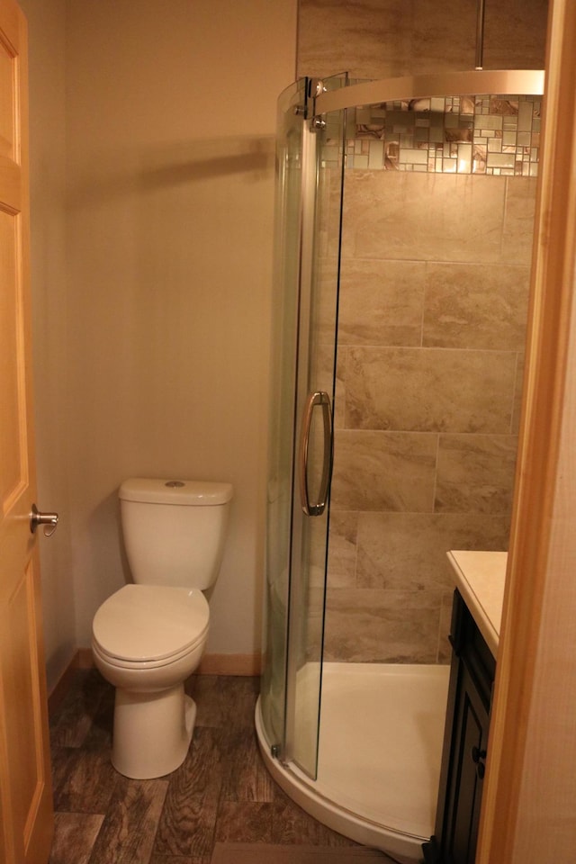 bathroom with vanity, toilet, and walk in shower