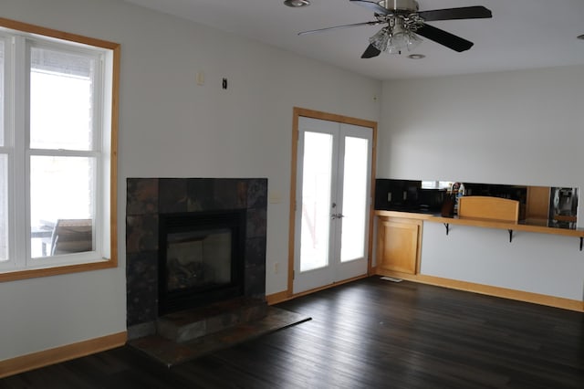 living room with ceiling fan, a healthy amount of sunlight, dark wood-type flooring, and french doors