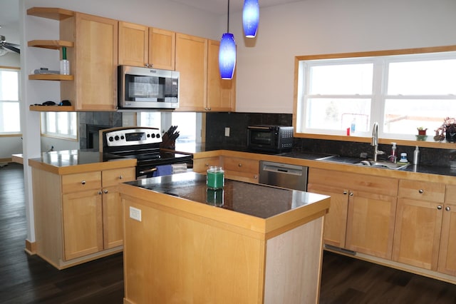 kitchen featuring light brown cabinets, sink, plenty of natural light, a kitchen island, and stainless steel appliances