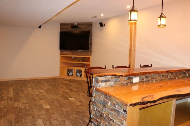 bar featuring pendant lighting and wood-type flooring