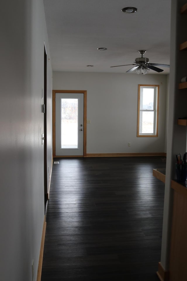 interior space featuring plenty of natural light, ceiling fan, and dark hardwood / wood-style floors