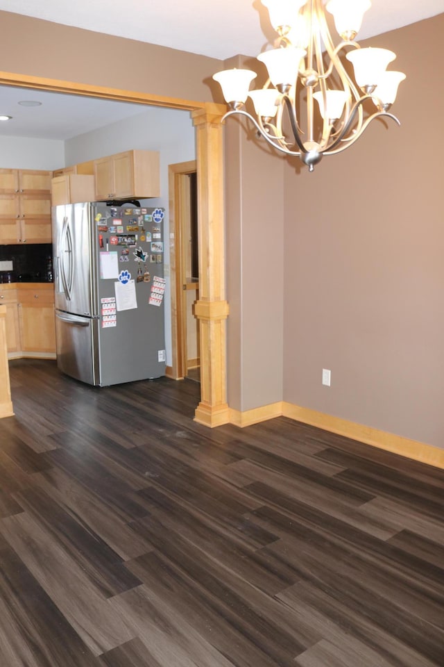 kitchen with light brown cabinets, dark hardwood / wood-style flooring, a notable chandelier, stainless steel fridge, and decorative backsplash