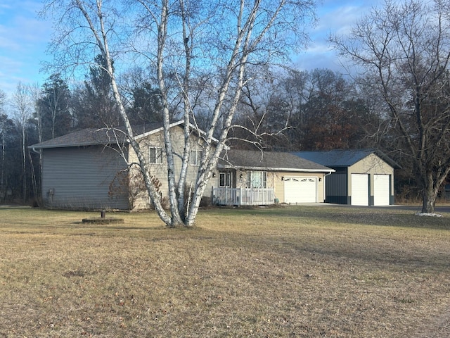 ranch-style house featuring a garage and a front lawn