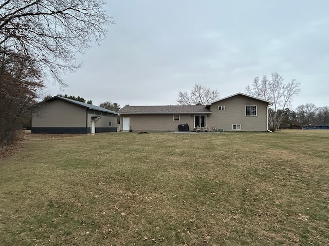 rear view of house featuring a lawn