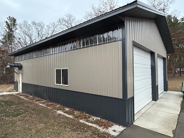 view of property exterior featuring a garage and an outbuilding