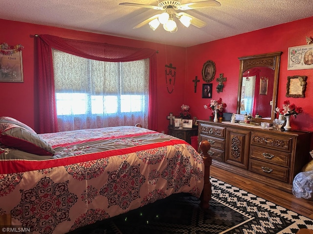 bedroom with ceiling fan and a textured ceiling