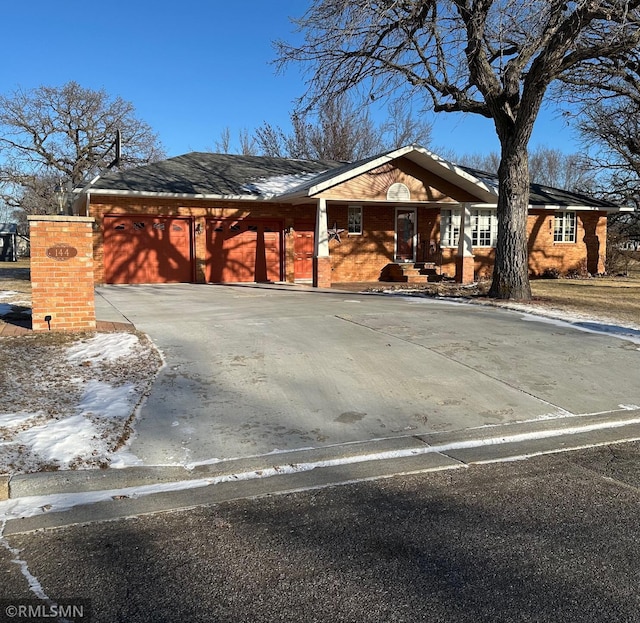 view of front of property featuring concrete driveway and a garage