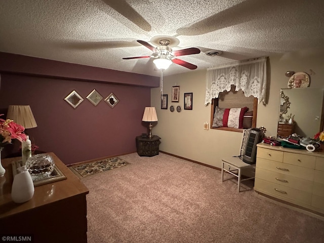 interior space featuring ceiling fan, a textured ceiling, and visible vents