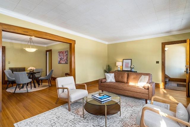 living room with light hardwood / wood-style flooring and ornamental molding